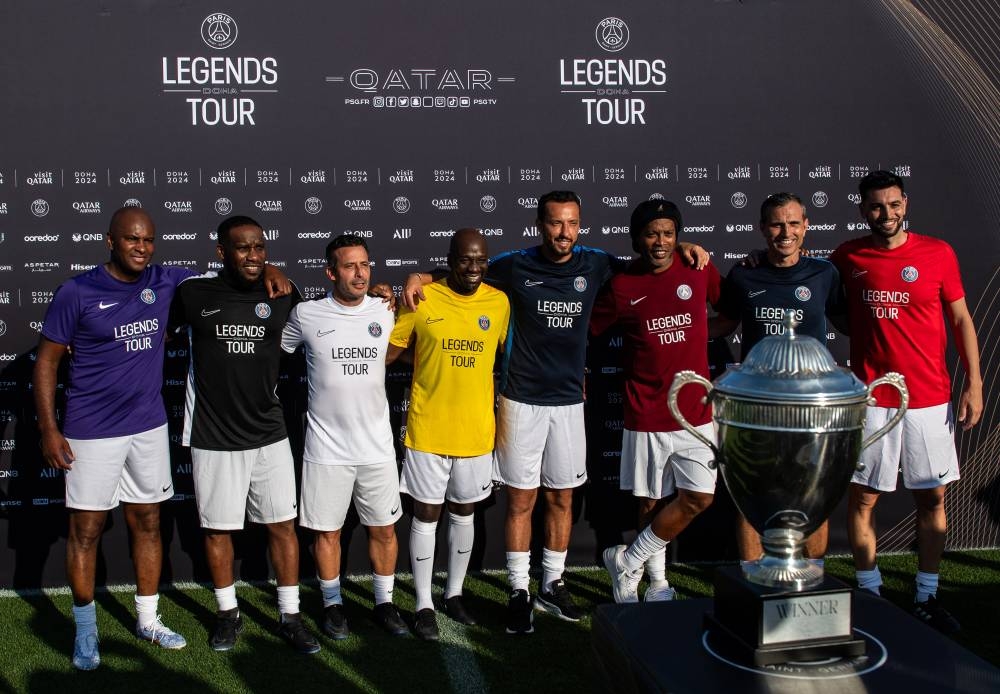DOHA, QATAR - FEBRUARY 14: Didier Domi, Jay-Jay Okocha, Ludovic Giuly, Claude Makélélé, Nene, Ronaldinho, Pauleta and Javier Pastore pose for a photo during the PSG Legends Tour on February 14, 2024 in Doha, Qatar. (Photo by Martin Dokoupil - PSG/PSG via Getty Images)